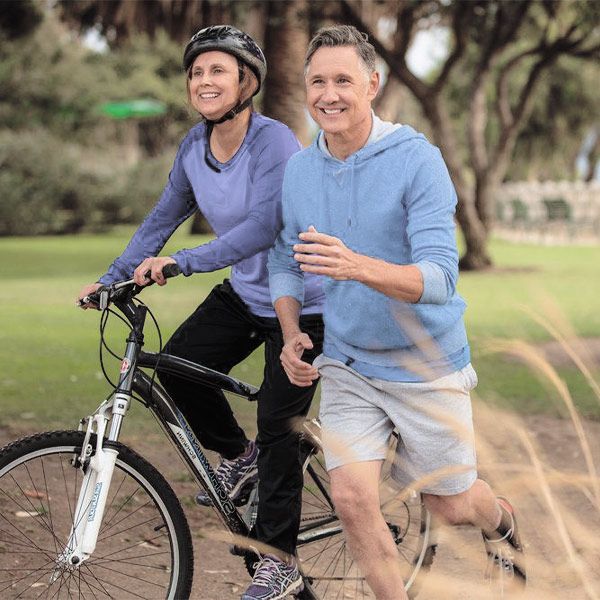 Couple jogging and biking
