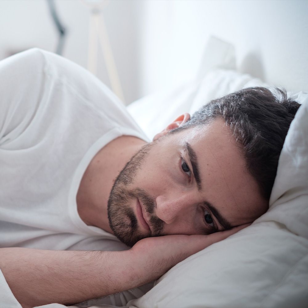 Restless man awake in bed